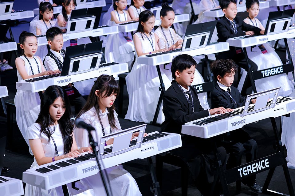 Young pianists performing on TERENCE pianos at the concert